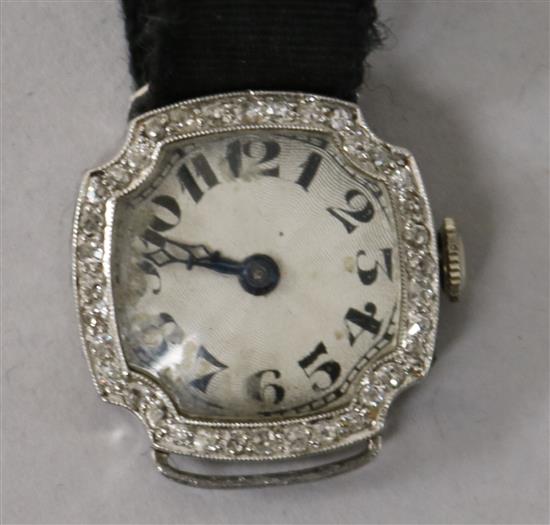 A ladys platinum and diamond cocktail watch, with Arabic dial and fabric strap.